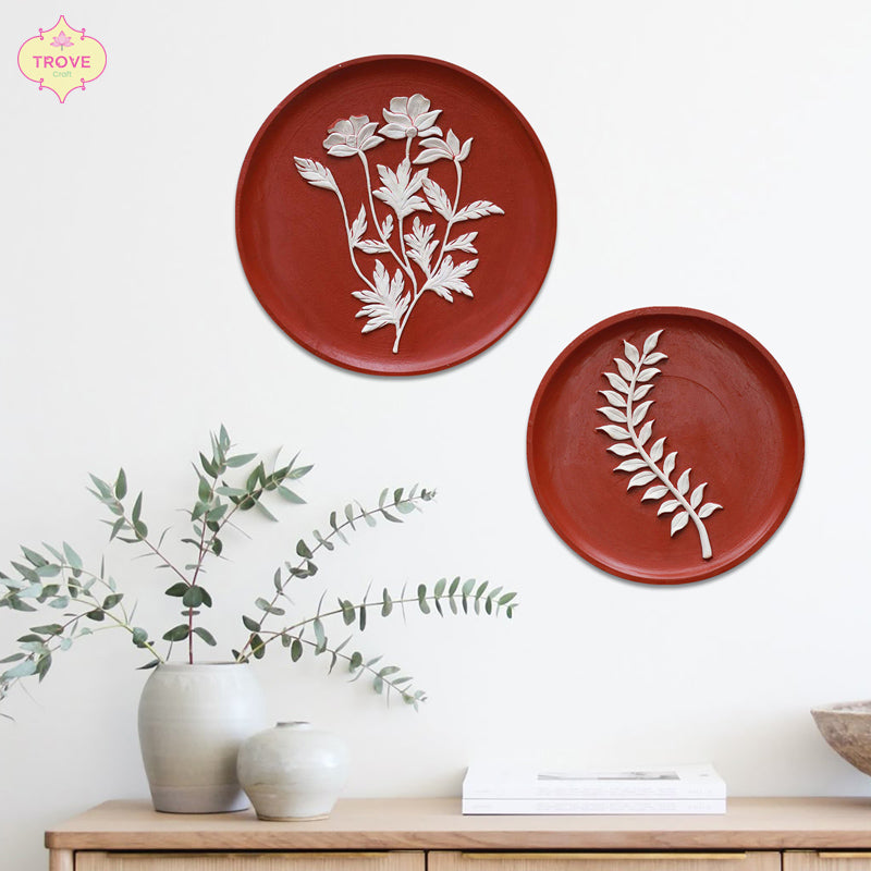 terracotta decorative wall plates with white embossed botanical designs
